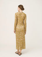 Woman wearing a patterned dress on a white background