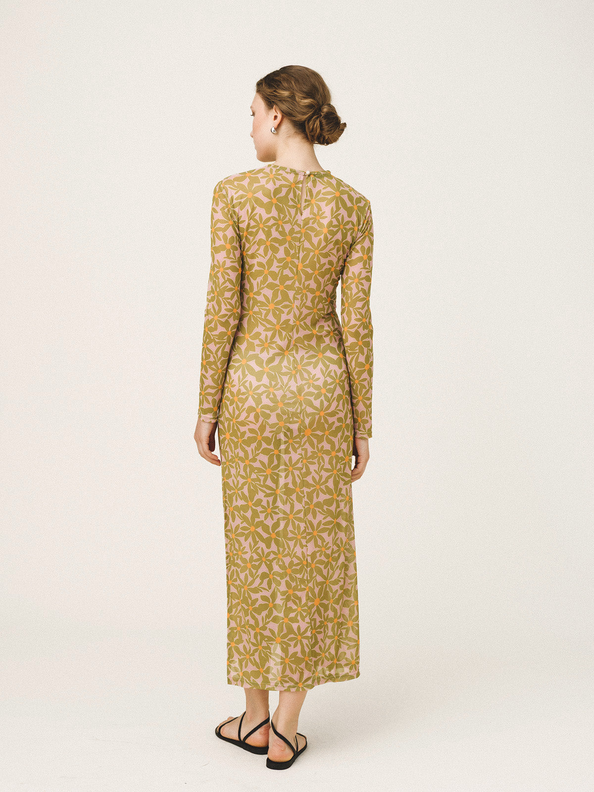 Woman wearing a patterned dress on a white background
