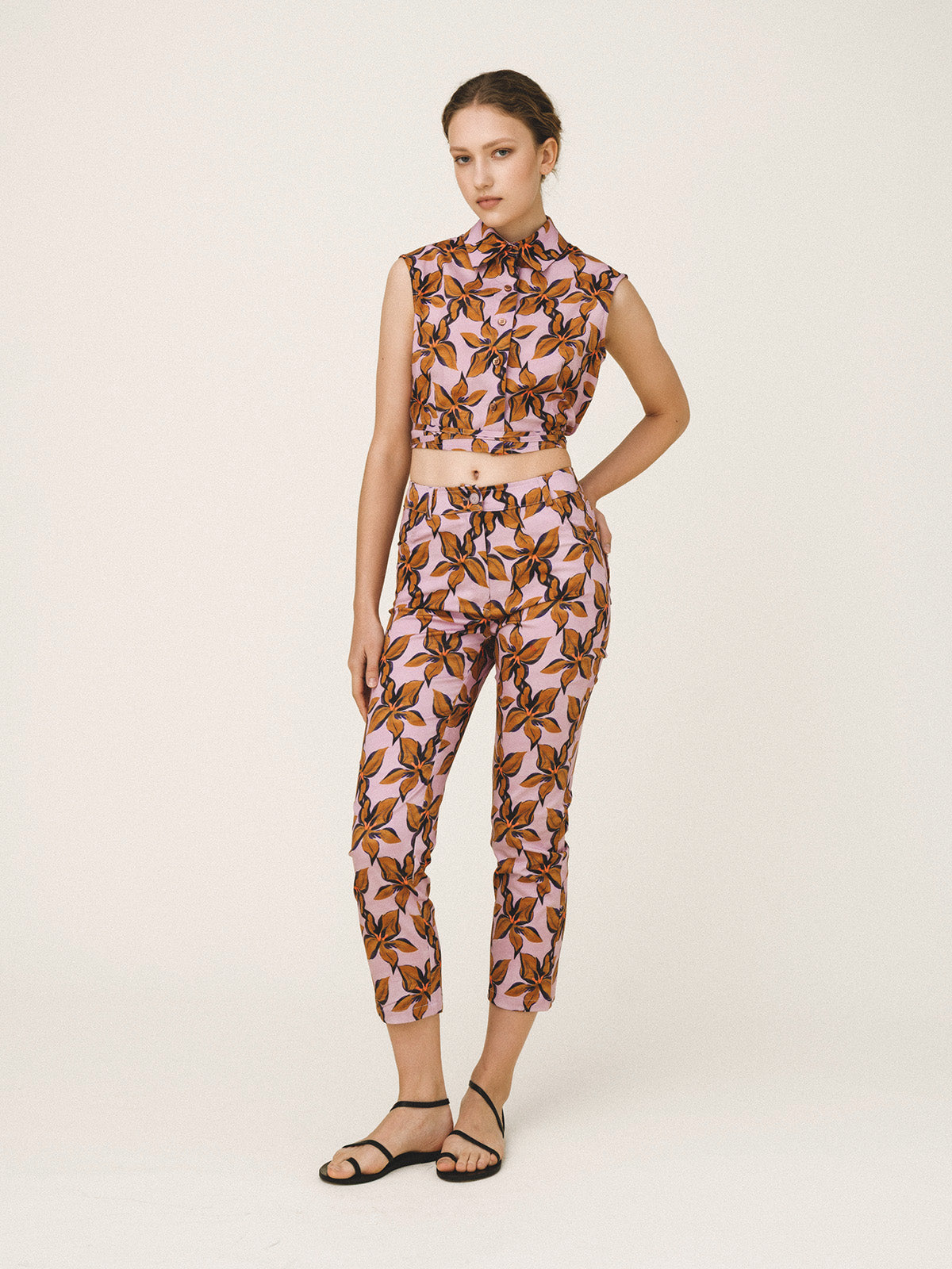 Woman wearing a patterned outfit on a white background