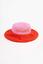 Pink and red bucket hat with 'Sun of a Beach' text on a white background