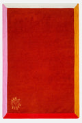 Red fabric with pink and yellow borders and a logo in the corner