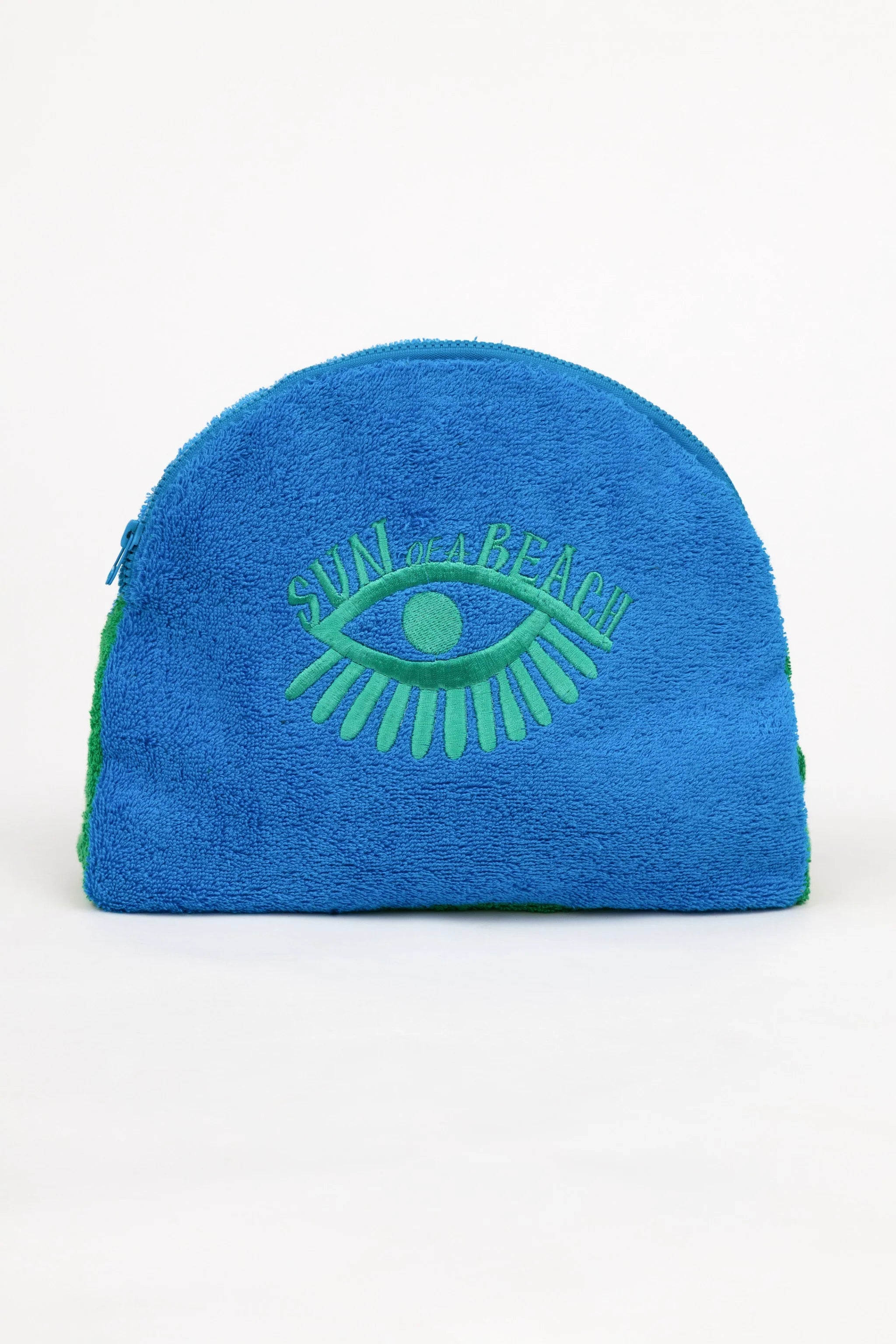 Blue towel with green eye design on a white background