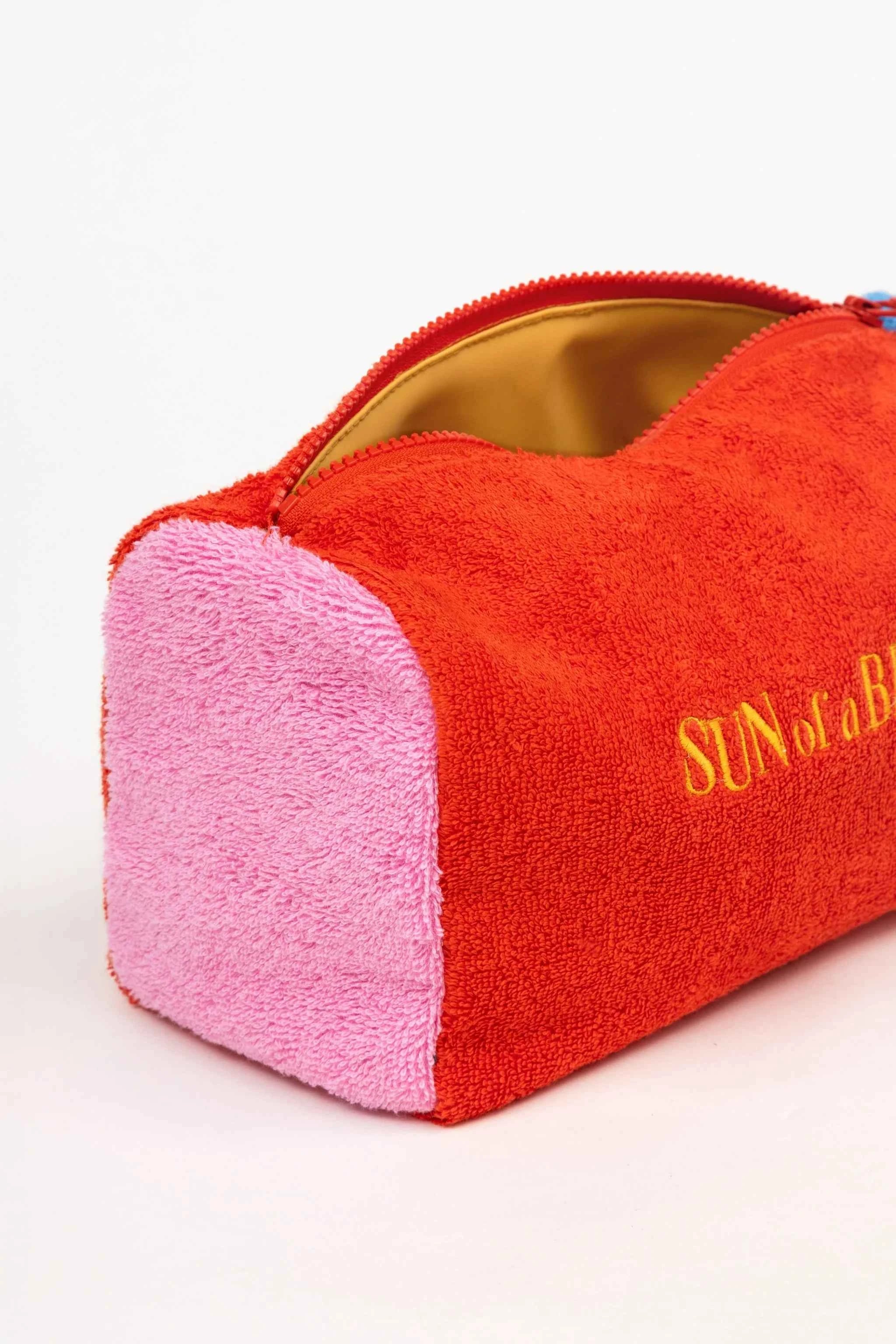 Red and pink pouch with 'Sun of a Bitch' text on a white background