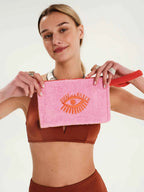 Woman holding a pink towel with a logo on a white background