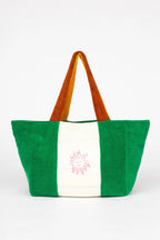 Green and white tote bag with brown handle on a white background
