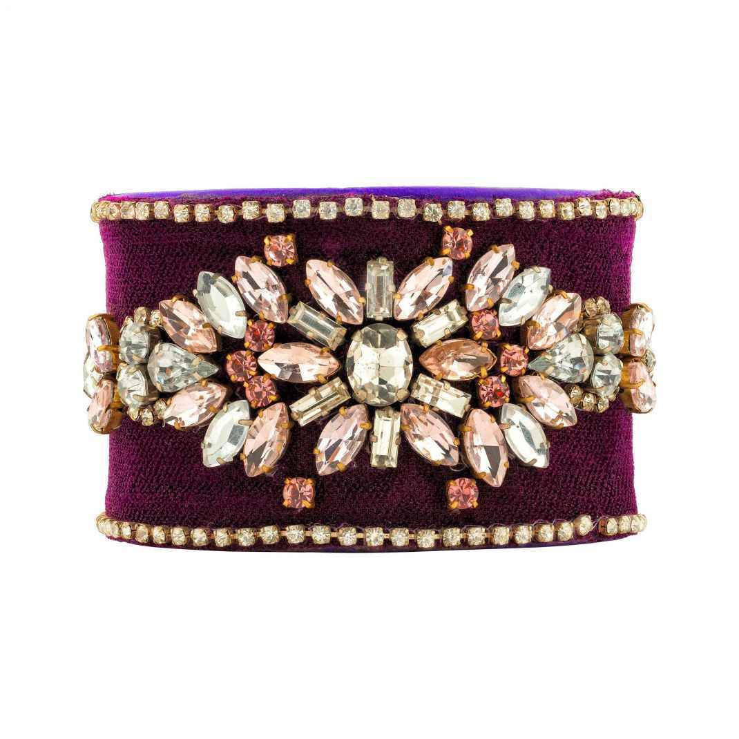 Purple clutch with decorative gemstones on a white background