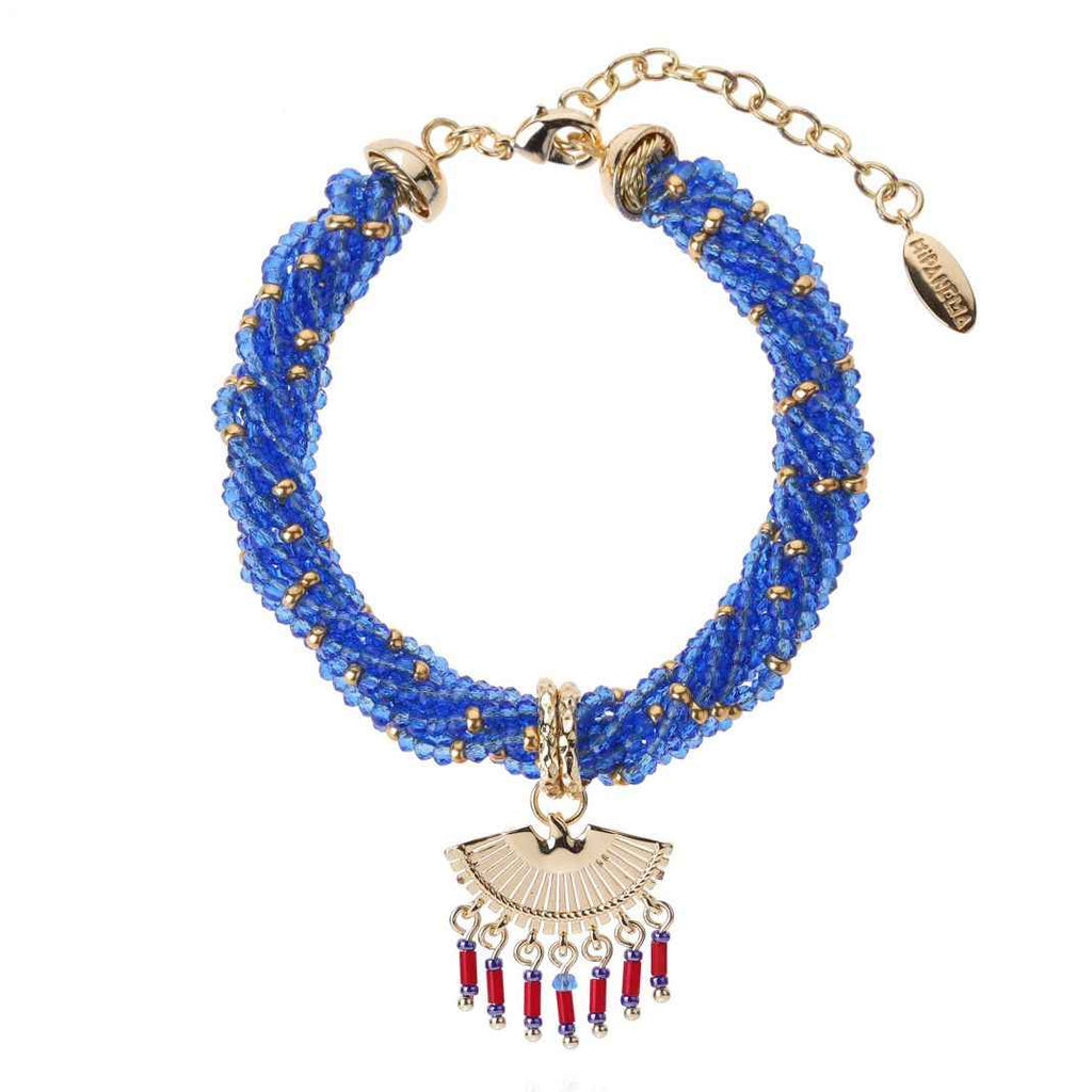 Blue beaded bracelet with gold and red pendant on a white background