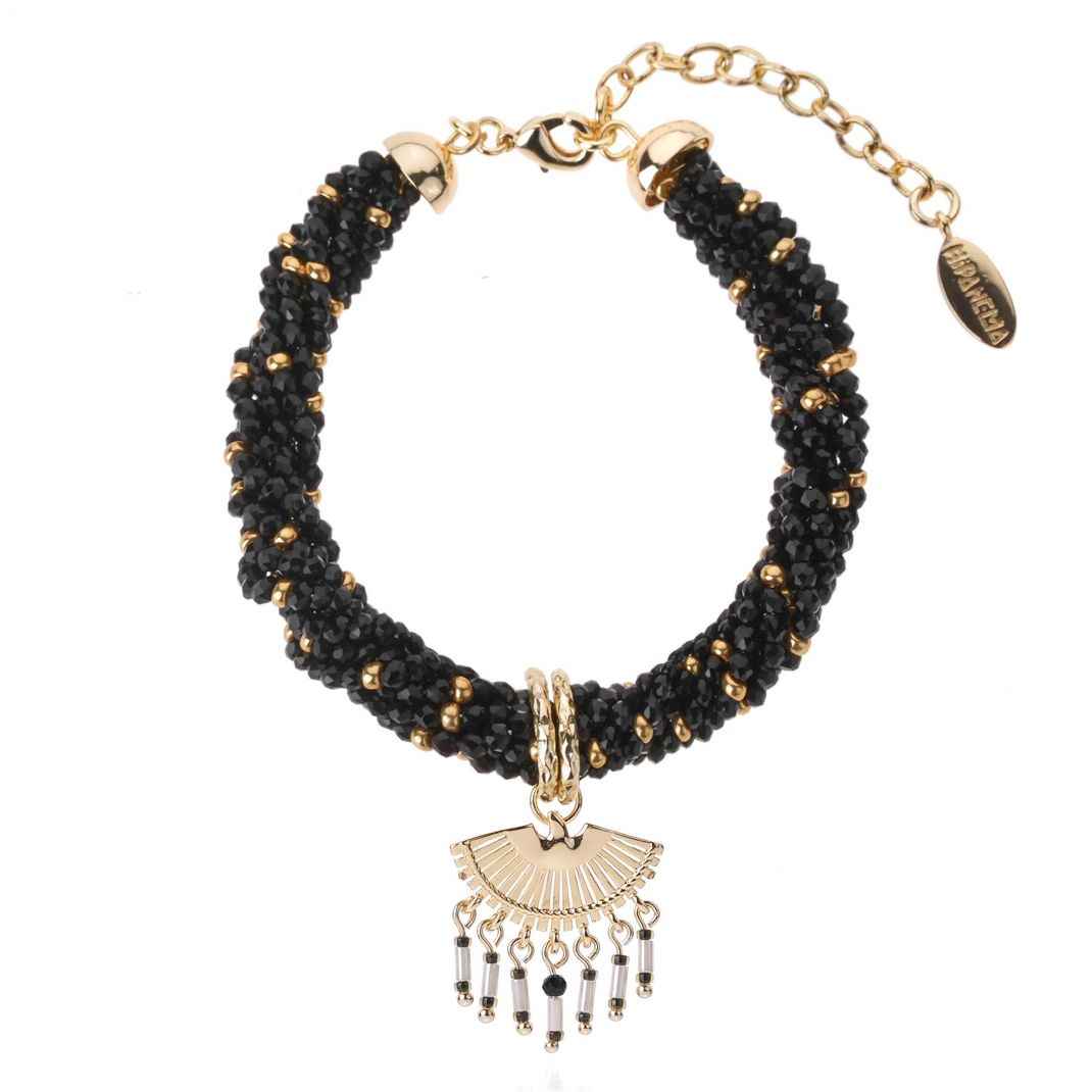 Black beaded bracelet with gold accents and a decorative charm on a white background