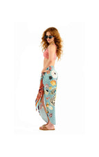Woman wearing a colorful sarong with a white background