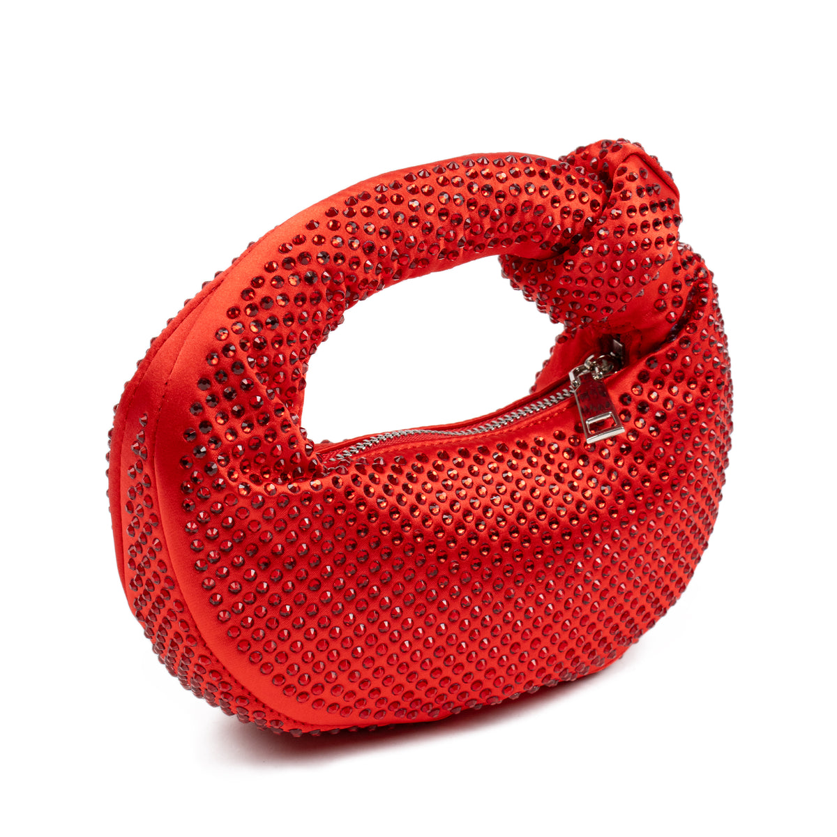 A bright red satin crescent clutch bag covered in sparkling rhinestones, featuring a knotted top handle and a silver zipper closure, set against a plain white background.