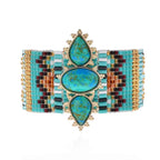 Multicolored beaded bracelet with turquoise stones on a white background