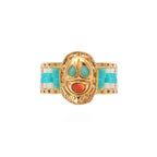 Gold ring with turquoise and coral accents on a white background