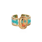 Gold ring with colorful beaded band on a white background