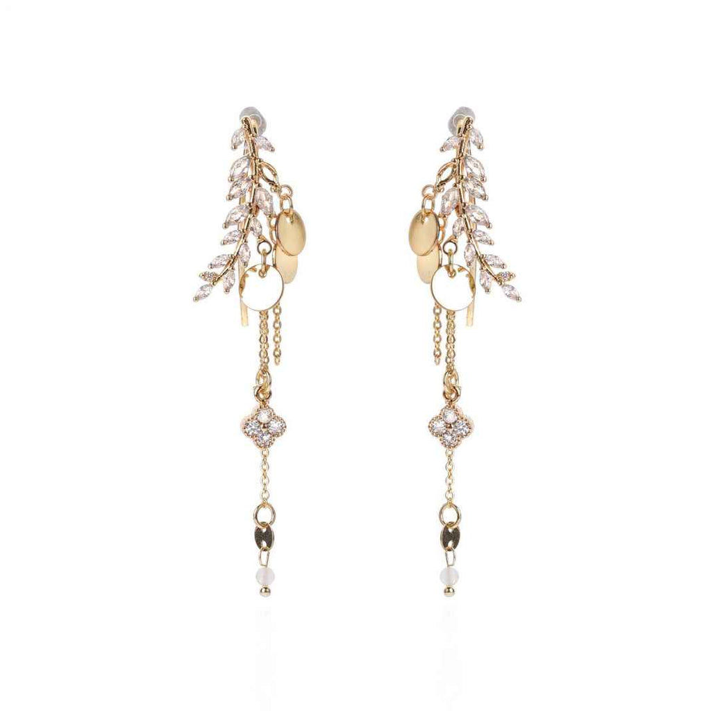Gold and pearl drop earrings on a white background