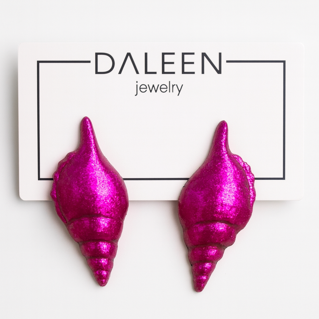 Pink shell-shaped earrings on a Daleen Jewelry card.