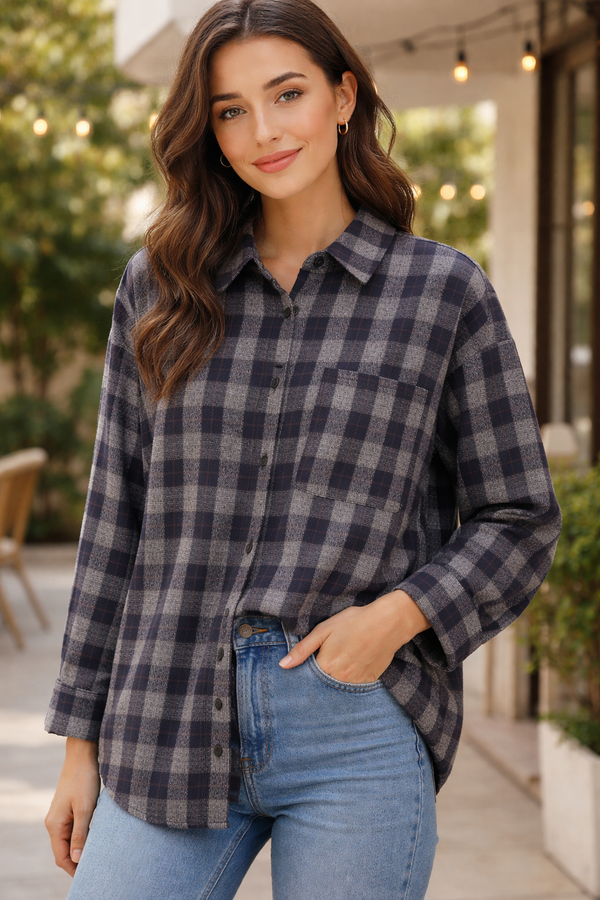 Woman wearing a plaid shirt and jeans outdoors