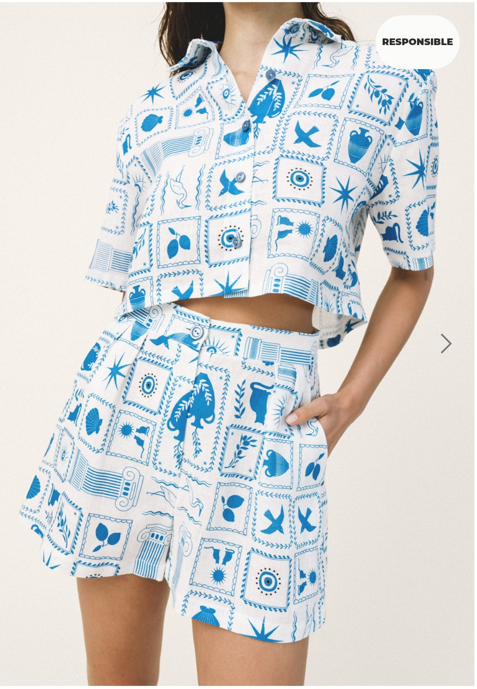 Person wearing a blue and white patterned outfit on a plain background