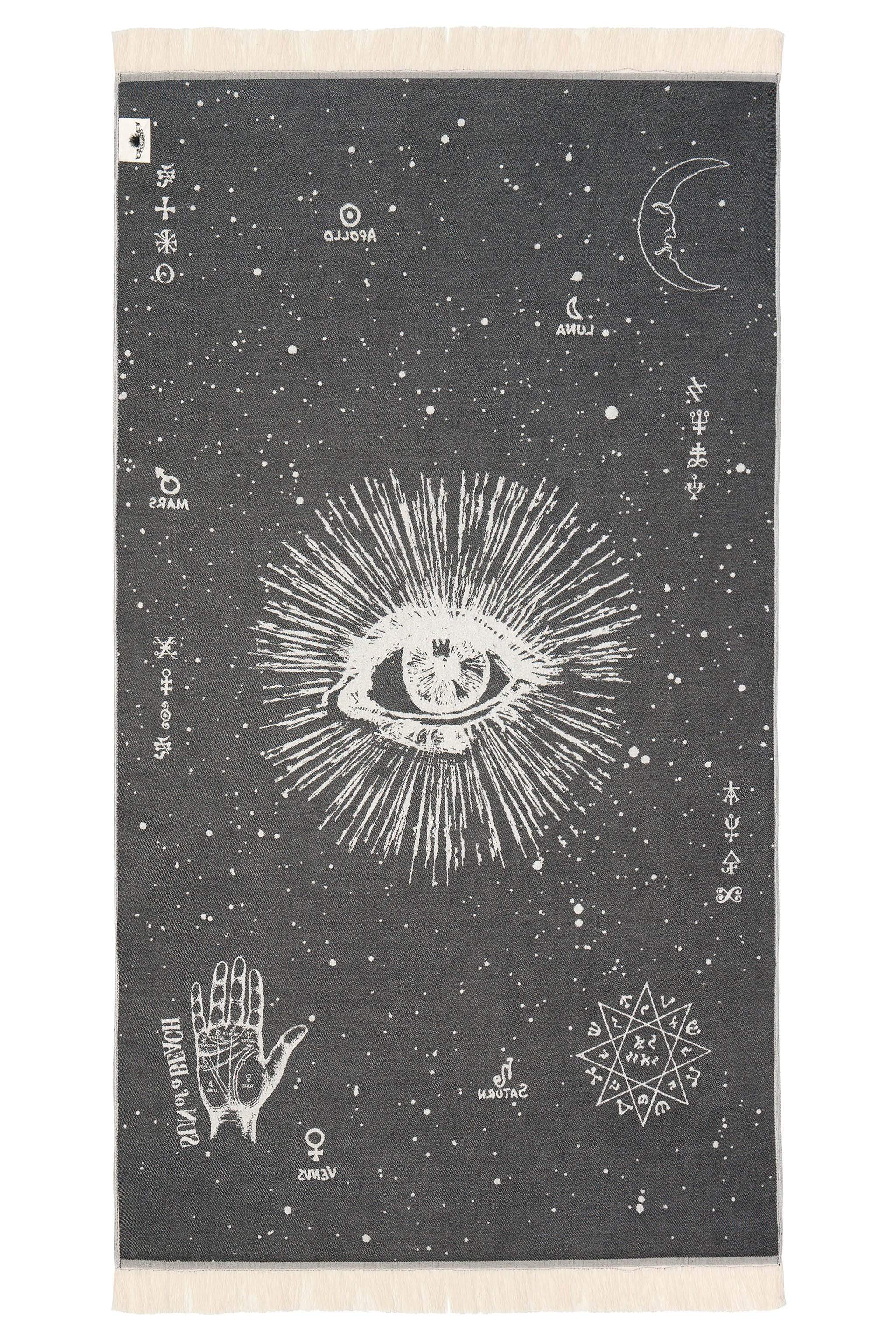 Towel with celestial design featuring an eye, hand, and geometric patterns on a dark background.