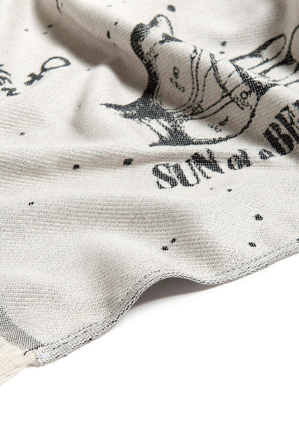 Close-up of a fabric with black text and graphics on a white background
