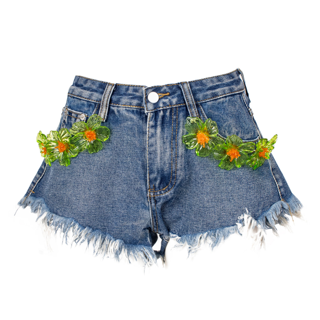 Denim shorts with floral embellishments on a white background