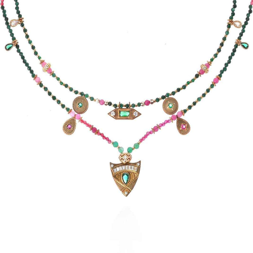 Multistrand necklace with beads and pendants on a white background