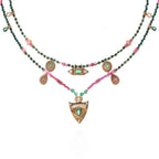 Multistrand necklace with beads and pendants on a white background