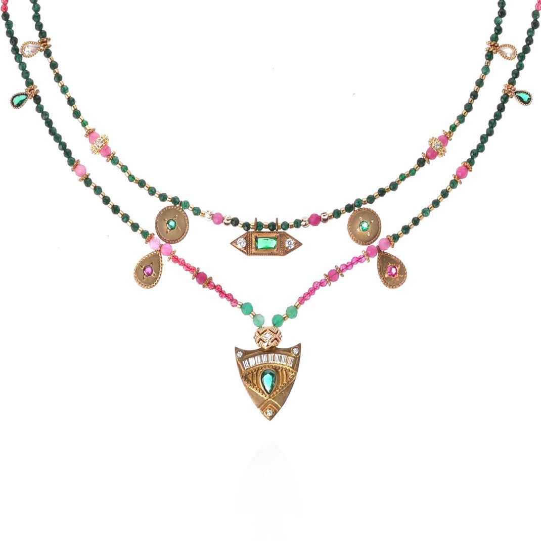 Multistrand necklace with beads and pendants on a white background