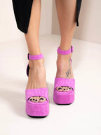 Pink platform heels worn by a person on a white background