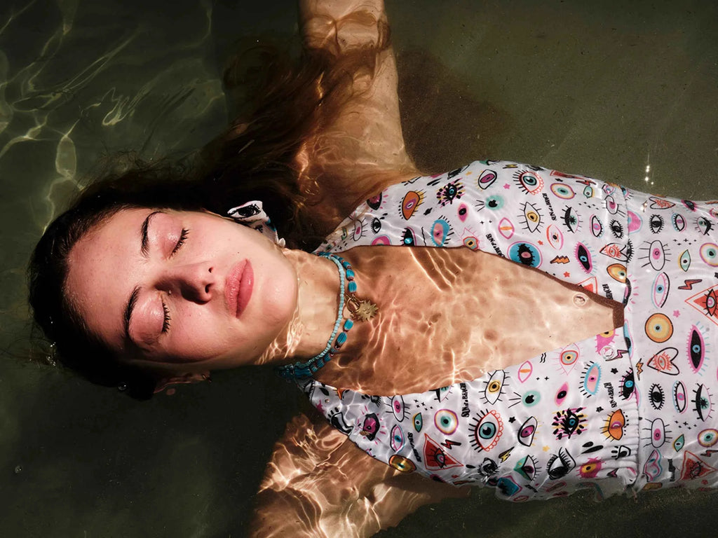 Person wearing a colorful swimsuit lying in water