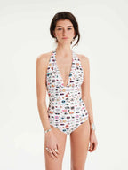 Woman wearing a patterned one-piece swimsuit on a white background