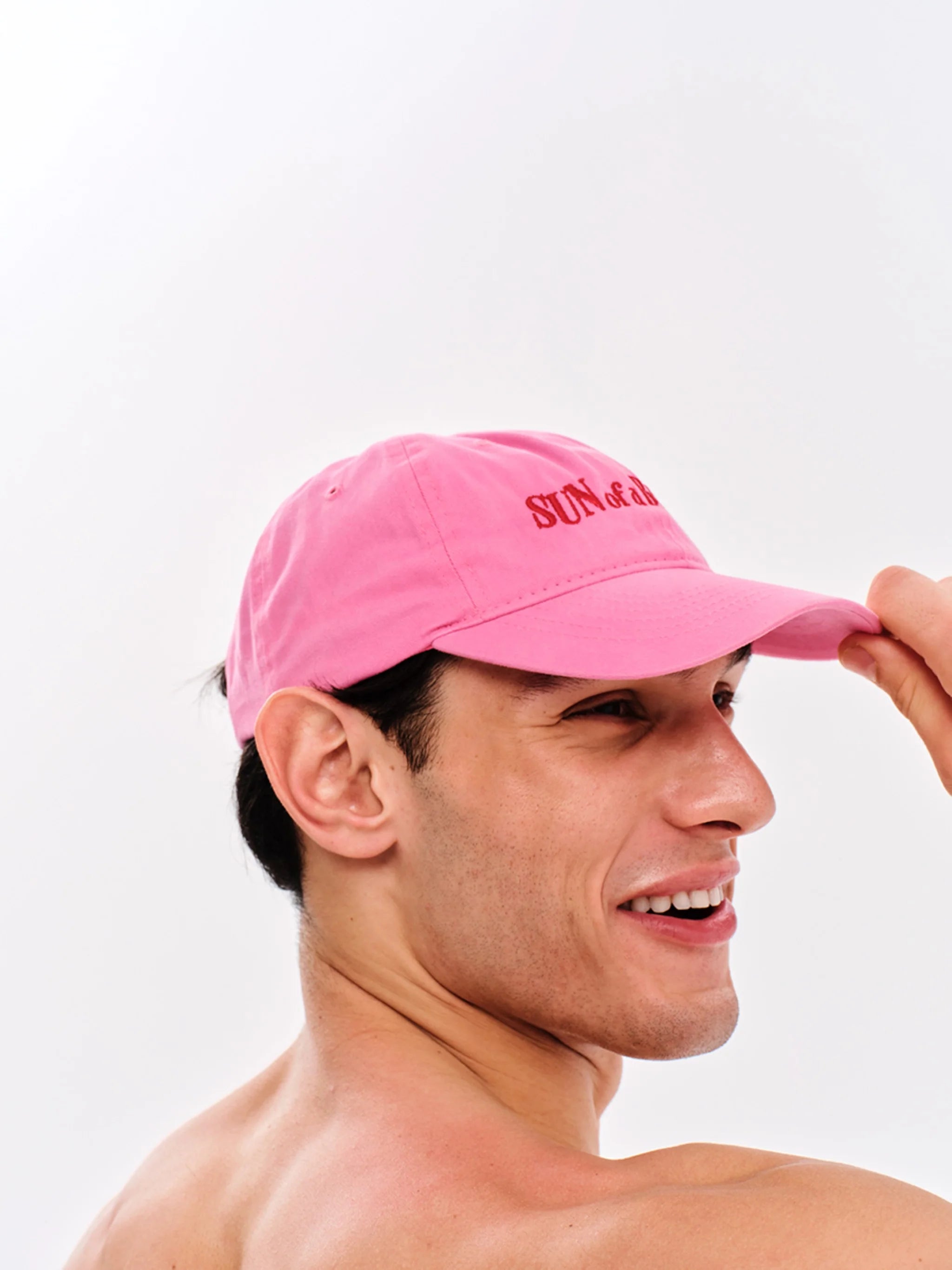 Man wearing a pink cap with text on a white background
