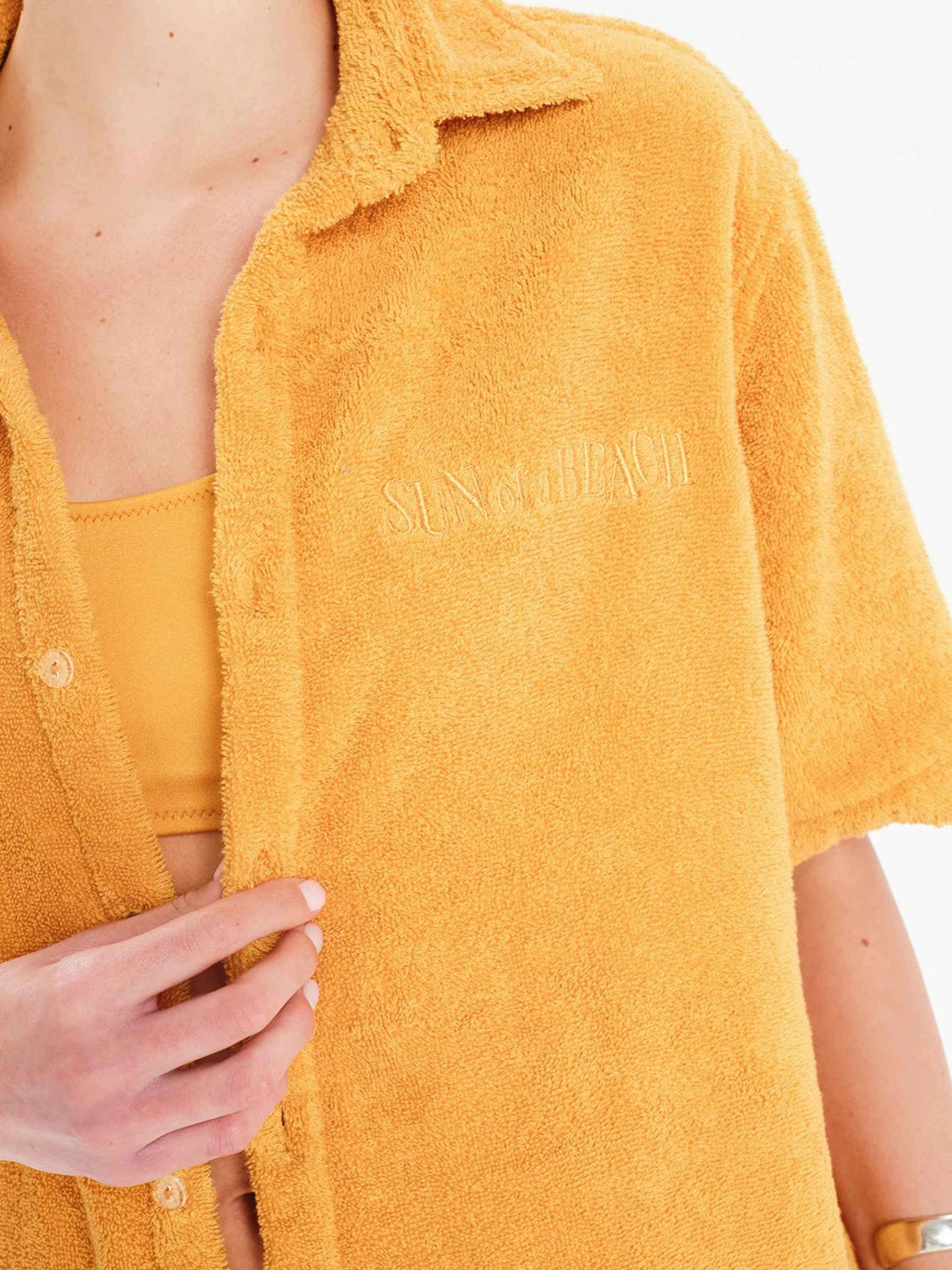 Yellow textured shirt with 'Sung Munch' branding on a white background