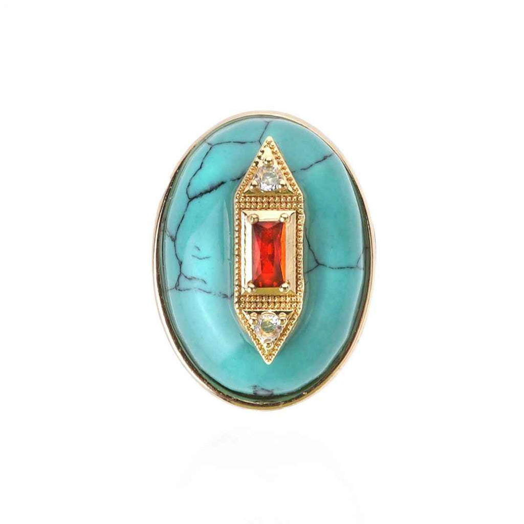 Turquoise ring with gold and red gemstone on a white background