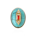 Turquoise ring with gold and red gemstone on a white background