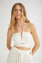 Woman wearing a white dress with a plain background