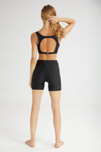 Person wearing a black athletic outfit on a white background