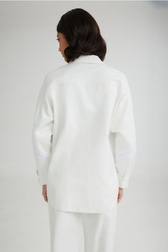 Person wearing a white outfit on a plain background