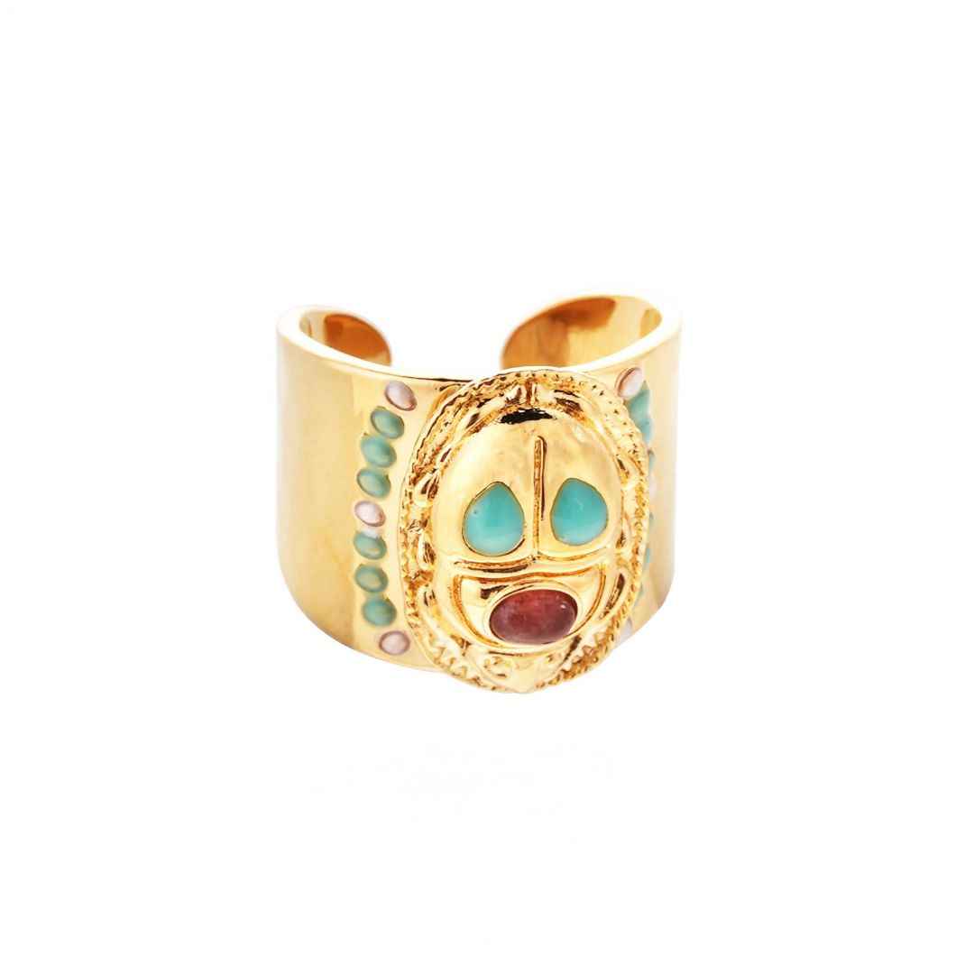 Gold ring with colorful stones on a white background