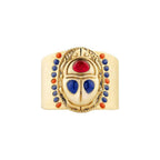 Gold ring with colorful gemstones on a white background