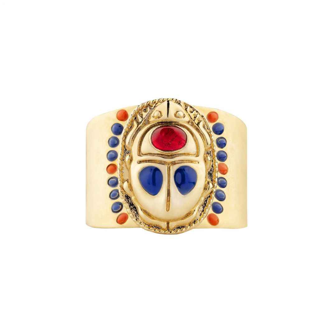 Gold ring with colorful gemstones on a white background