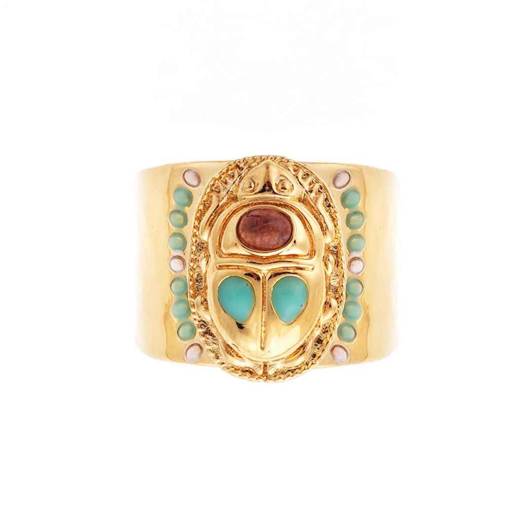 Gold ring with turquoise and pink stones on a white background