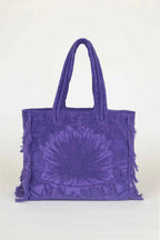 Purple tie-dye tote bag with fringes on a white background