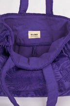 Purple bag with a visible brand label on a white background