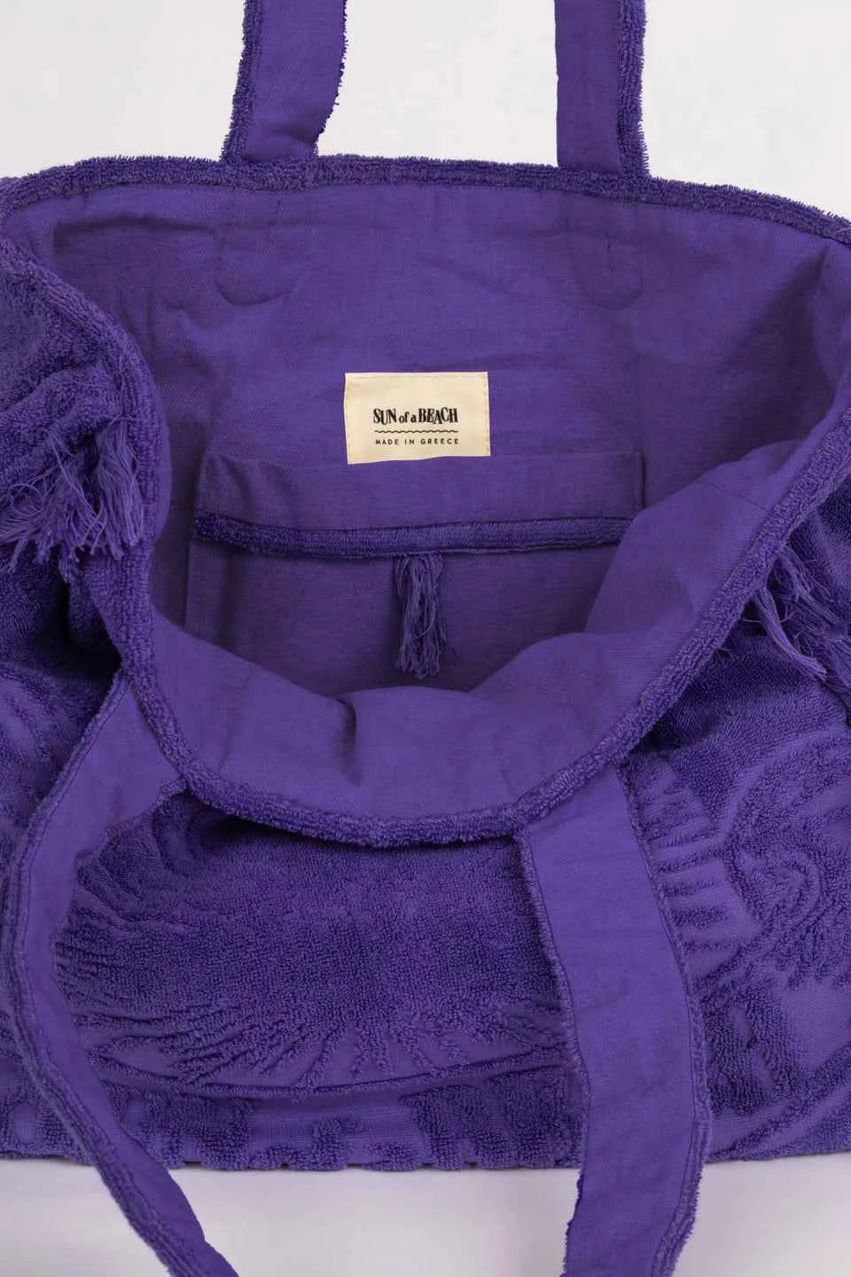 Purple bag with a visible brand label on a white background
