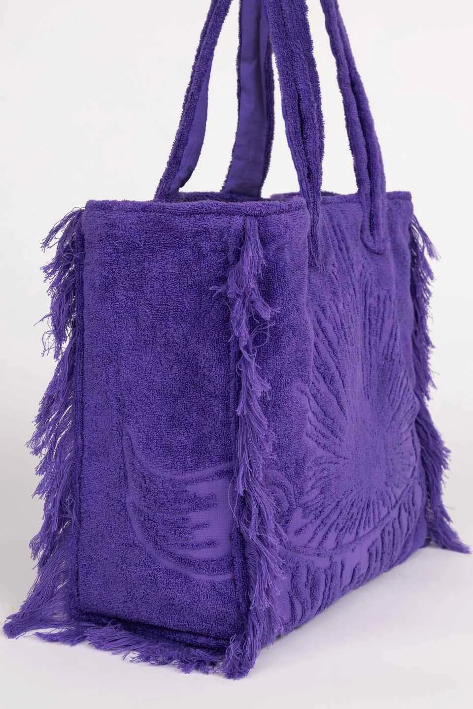 Purple fringed handbag on a white background