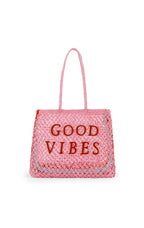 Pink tote bag with 'Good Vibes' text on a white background