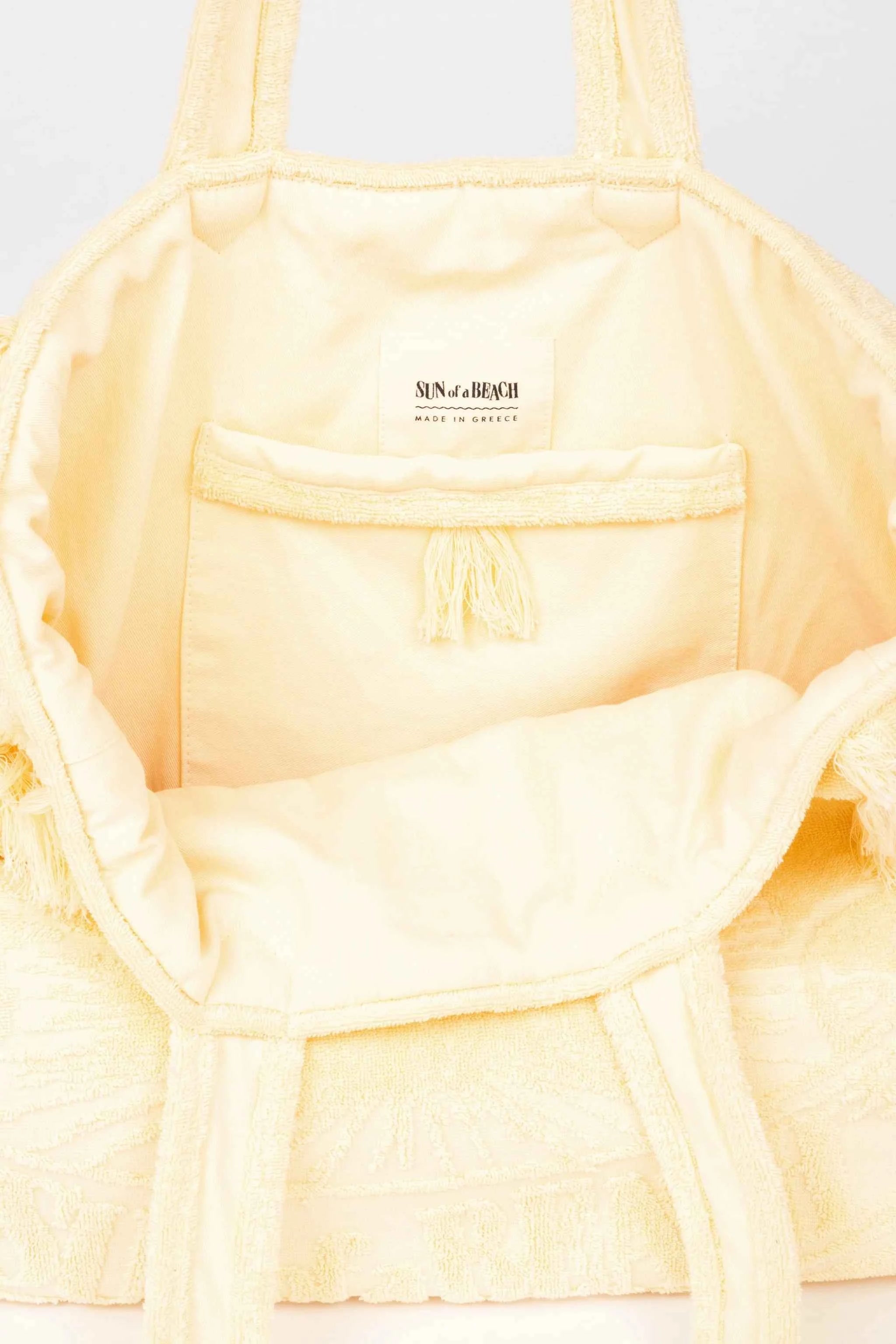 Light yellow bra with 'Ninety Percent' branding on a light gray background