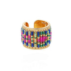 Gold ring with colorful bead detailing on a white background