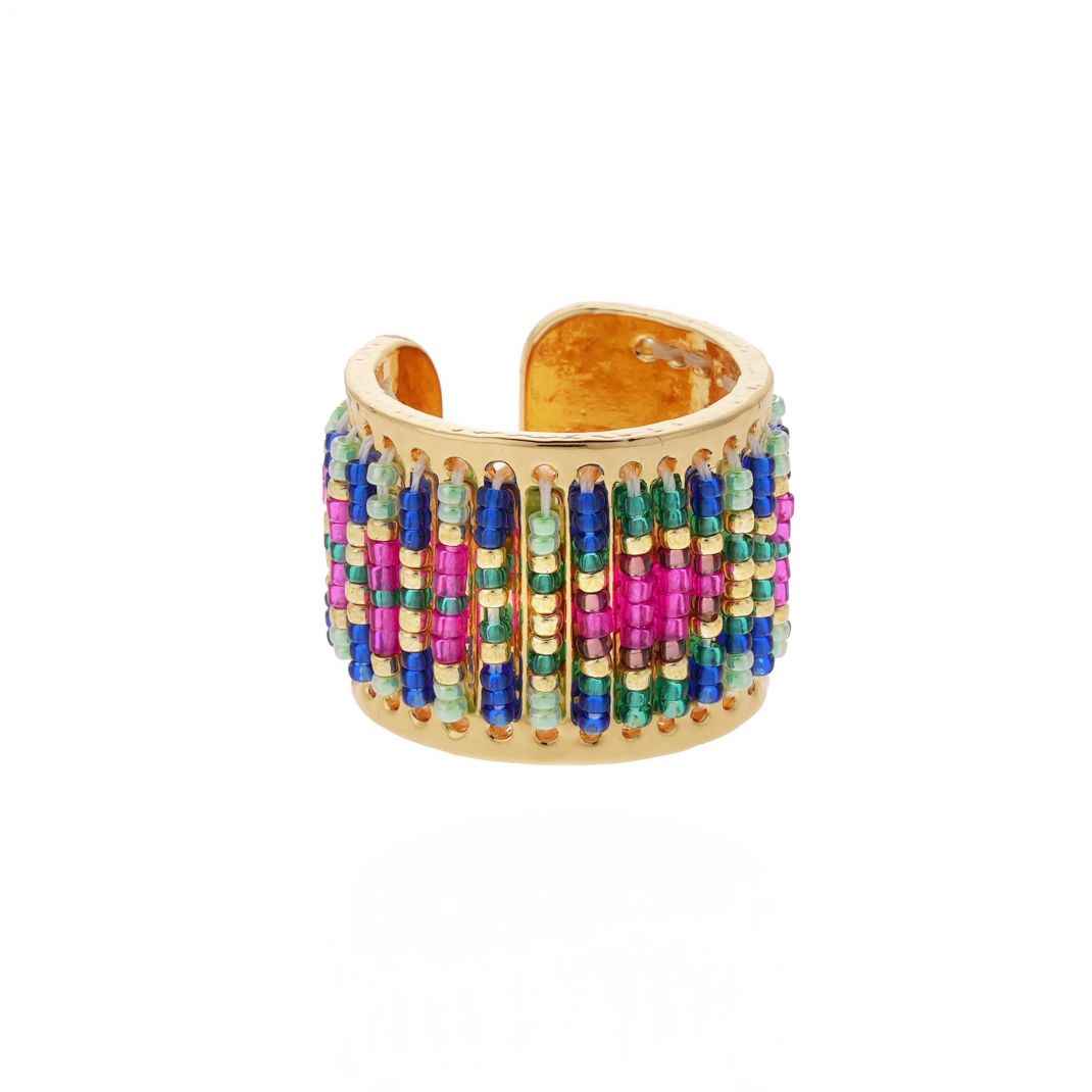 Gold ring with colorful bead detailing on a white background
