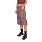 A pair of high waist denim shorts with leopard print design on a female mannequin.